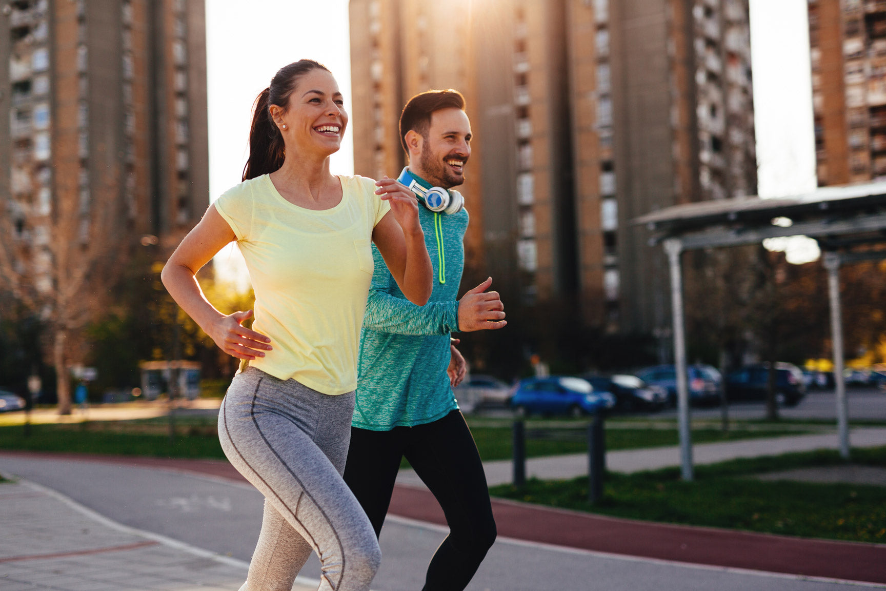 Woman and man running in athletic clothes after supplementing with liquid collagen supplements.