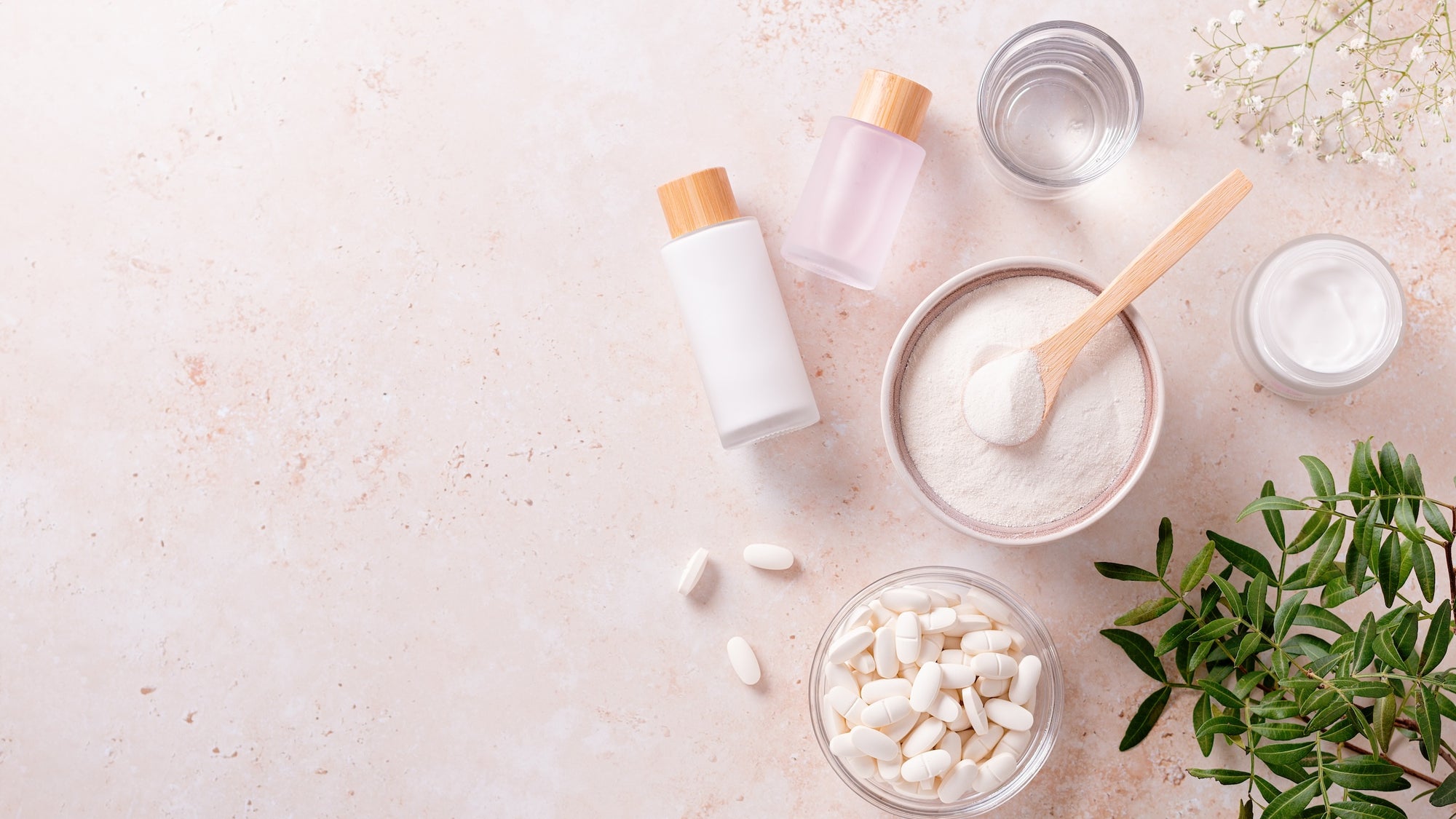 Different types of collagen products layed out: pills, powder, lotion, liquid